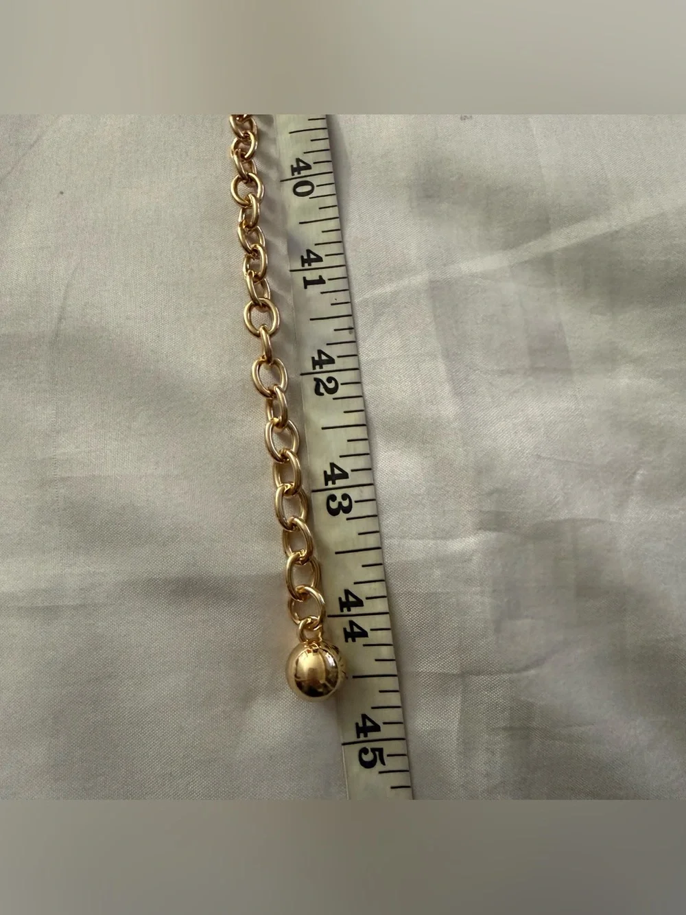 Gold tone metal chain belt with rhinestone details